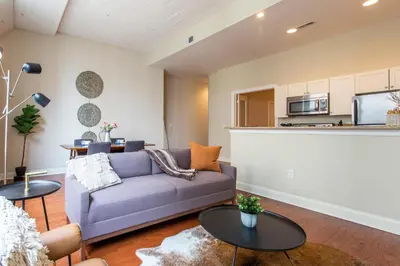 a living room with a purple couch and tables at Sleeps 4! 2BR, Gym, Paid Parking, Close to Major Attractions in Philadelphia