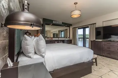 a bedroom with a large bed and a television at Ghost Light Inn in New Hope