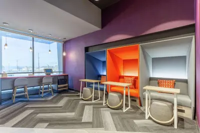 a room with tables and chairs and a window at Tru By Hilton Binghamton Vestal in Vestal