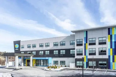 a large white building with a lot of windows at Tru By Hilton Binghamton Vestal in Vestal