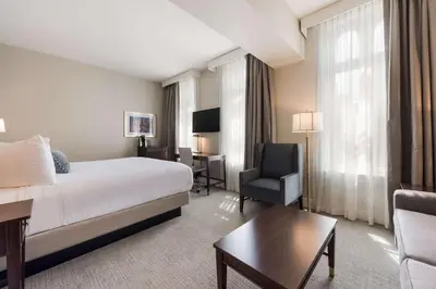 a hotel room with a bed and a desk and a chair at Independence Park Hotel, BW Premier Collection in Philadelphia