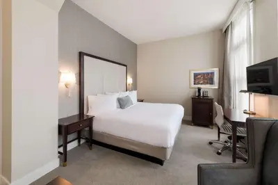 a hotel room with a bed and a desk and a television at Independence Park Hotel, BW Premier Collection in Philadelphia