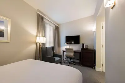 a hotel room with a bed and a desk and a chair at Independence Park Hotel, BW Premier Collection in Philadelphia