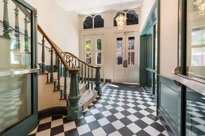 a hallway with a staircase and a checkered floor at Independence Park Hotel, BW Premier Collection in Philadelphia