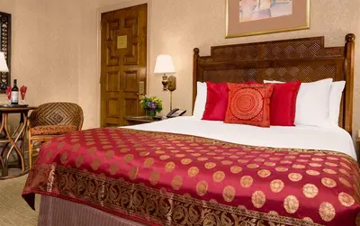 a hotel room with a large bed with red pillows at Casablanca Hotel by Library Hotel Collection in New York