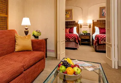 a living room with a couch and a bowl of fruit at Casablanca Hotel by Library Hotel Collection in New York