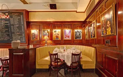 a dining room with a table and chairs at Casablanca Hotel by Library Hotel Collection in New York