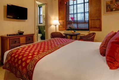 a bedroom with a large bed and a television at Casablanca Hotel by Library Hotel Collection in New York