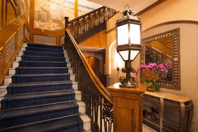 a stairway with blue stairs and a lamp at Casablanca Hotel by Library Hotel Collection in New York
