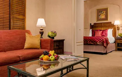 a living room with a couch and a table with a bowl of fruit at Casablanca Hotel by Library Hotel Collection in New York