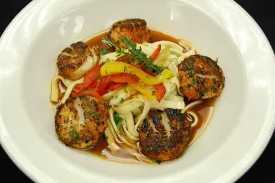 a white bowl of soup with meatballs and noodles at Radisson Lackawanna Station Hotel Scranton in Scranton