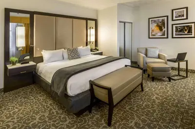 a hotel room with a large bed and a chair at Radisson Lackawanna Station Hotel Scranton in Scranton