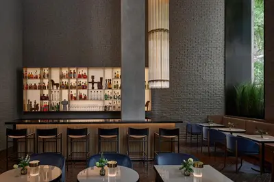 a restaurant with tables and chairs and a bar at Hotel AKA NoMad in New York