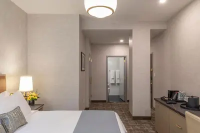 a hotel room with a bed and a bathroom at Broadway Plaza Hotel in New York