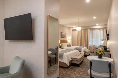 a hotel room with a bed and a mirror at Broadway Plaza Hotel in New York