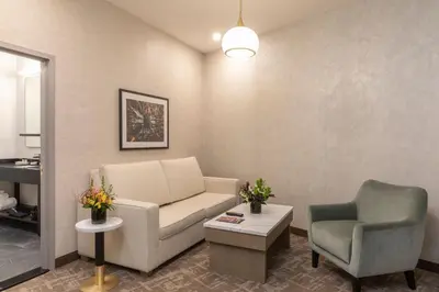 a living room with a couch and a chair at Broadway Plaza Hotel in New York