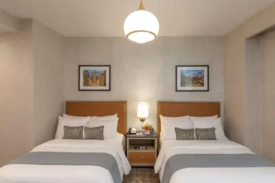 a hotel room with two beds and a lamp at Broadway Plaza Hotel in New York