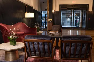 a lobby with chairs and a table and a table sidx sidx at Kixby in New York