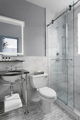 a bathroom with a shower and a toilet and a sink at Kixby in New York