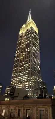 a tall building with lights on it at night at Kixby in New York