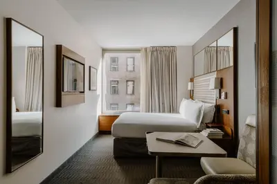 a hotel room with two beds and a table at Hotel Boutique at Grand Central in New York