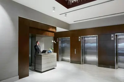 a man standing at a desk in a lobby at Hotel Boutique at Grand Central in New York