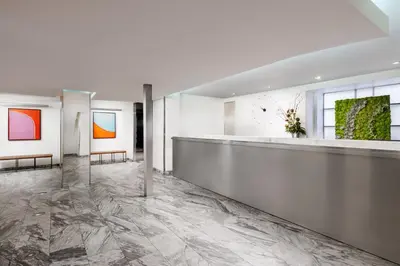 a lobby with a marble floor and paintings on the wall at The Shoreham in New York