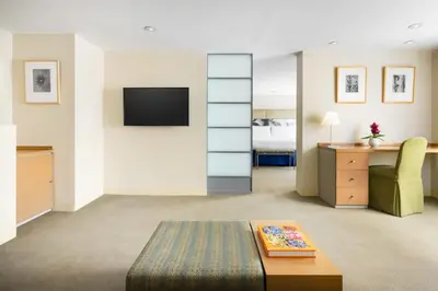 a room with a bed and a desk and a tv at The Shoreham in New York