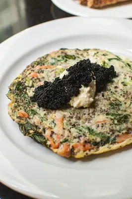 a piece of food on a white plate at The Algonquin Hotel Times Square, Autograph Collection in New York