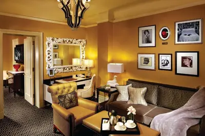 a living room with a couch and a mirror at The Algonquin Hotel Times Square, Autograph Collection in New York