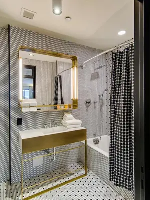 a bathroom with a sink and a mirror and a tub at Hotel Shocard Broadway, Times Square in New York