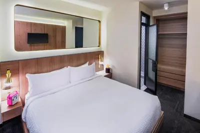 a bedroom with a white bed and a mirror at Hotel Shocard Broadway, Times Square in New York