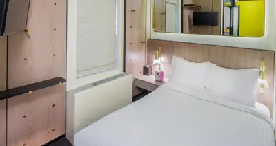 a bedroom with a white bed and a mirror at Hotel Shocard Broadway, Times Square in New York