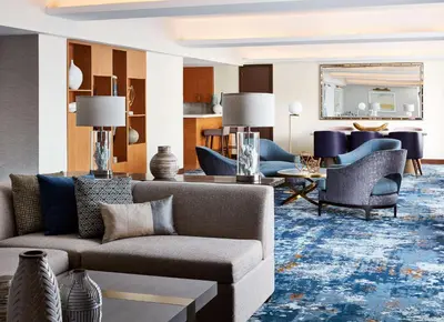 a living room with a couch and chairs at New York Hilton Midtown in New York