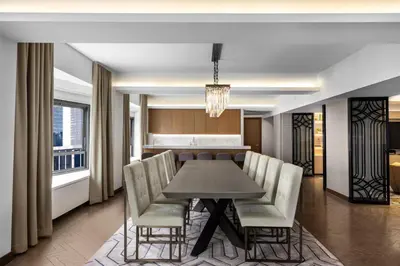 a dining room with a table and chairs at New York Hilton Midtown in New York