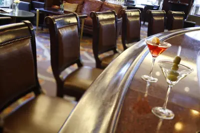 two martini glasses sitting on a table in a restaurant at Warwick New York in New York