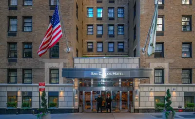 two people standing in front of the suntrust hotel at San Carlos Hotel New York in New York