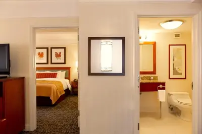 a bedroom with a bed and a bathroom with a toilet at San Carlos Hotel New York in New York