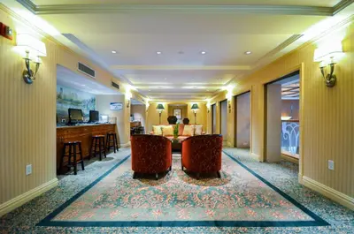a hotel lobby with two chairs and a table at San Carlos Hotel New York in New York