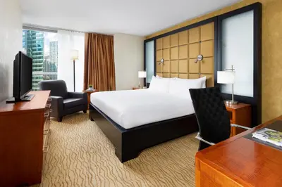 a hotel room with a bed and a desk at Millennium Hotel Broadway Times Square in New York