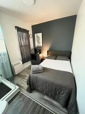 a bedroom with a large bed and a window at Shefah Hotel in Union City