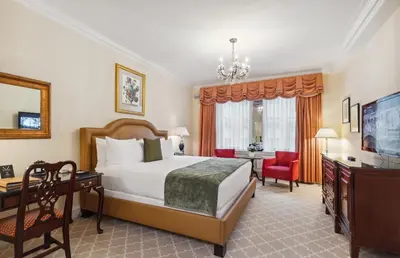 a hotel room with a bed and a desk at The Sherry Netherland in New York