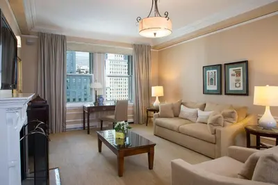 a living room with a couch and a table at The Sherry Netherland in New York
