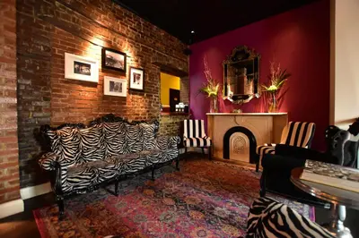 a living room with a couch and a fireplace at Sohotel in New York