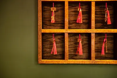 a wooden shelf with red tassels on it at Sohotel in New York