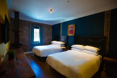 two beds in a room with blue walls at Sohotel in New York