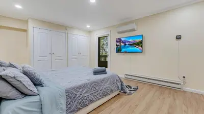 a bedroom with a bed and a tv on a wall at Cozy Modern Camelback House in Tannersville