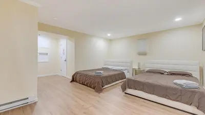 a bedroom with two beds and a flat screen tv at Cozy Modern Camelback House in Tannersville