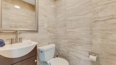 a bathroom with a sink and a toilet and a mirror at Cozy Modern Camelback House in Tannersville