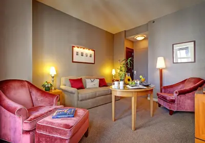 a living room with two chairs and a table at Hotel Giraffe by Library Hotel Collection in New York